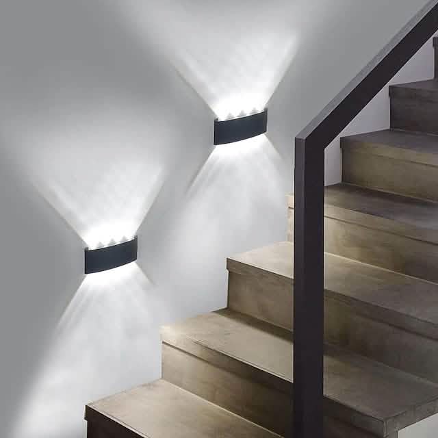 Two black outdoor waterproof wall lights with warm LED glow