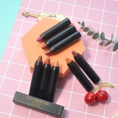 Hydrating lip crayon pencils, assorted shades, with open tips on a grid surface