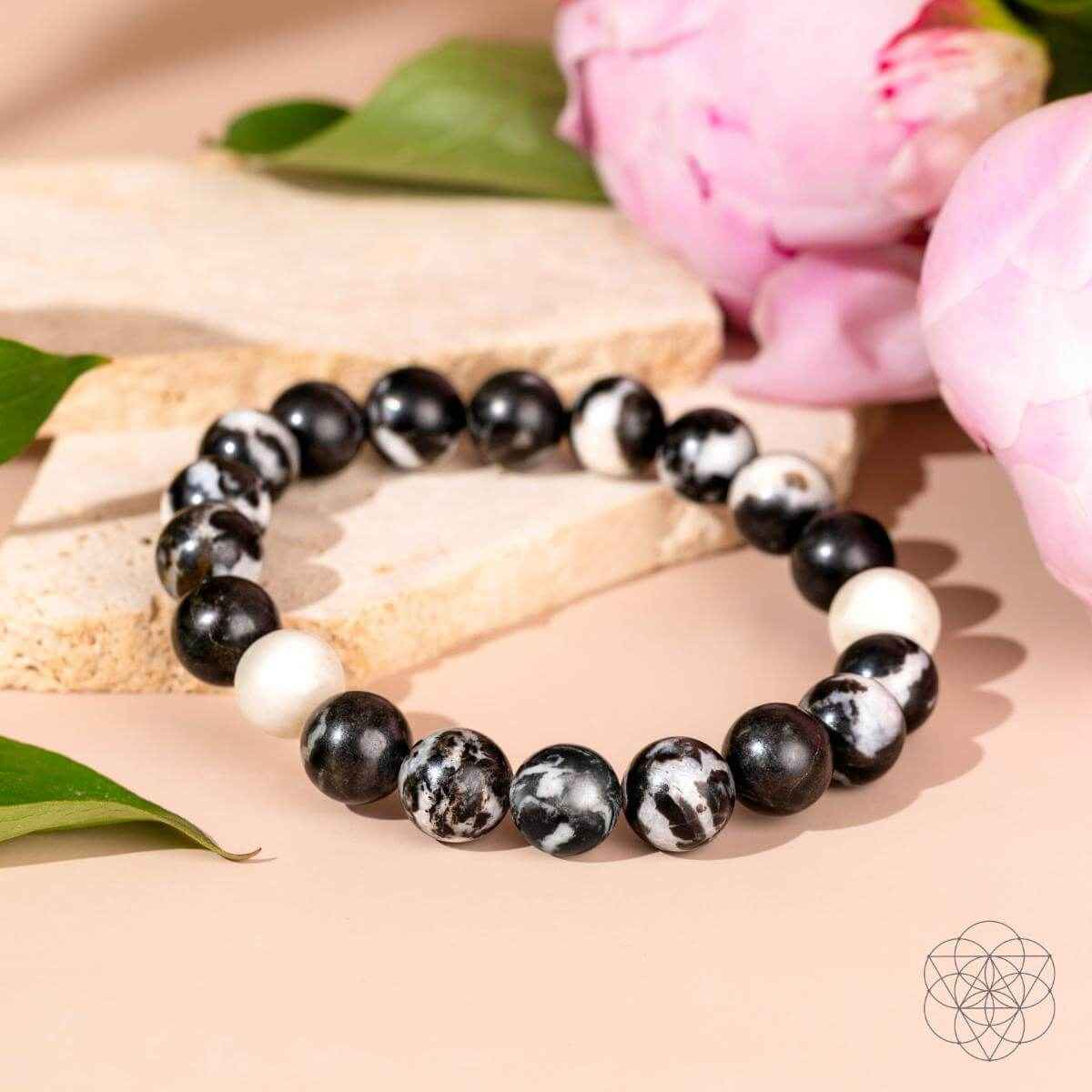 Zebra jasper beaded bracelet with black beads, white accents, and zebra-pattern stones