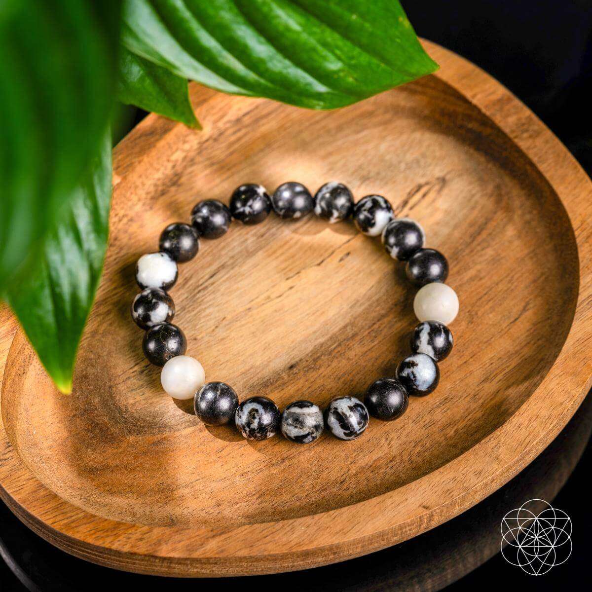 Zebra jasper beaded bracelet with black round stones, white accents, and zebra-pattern beads