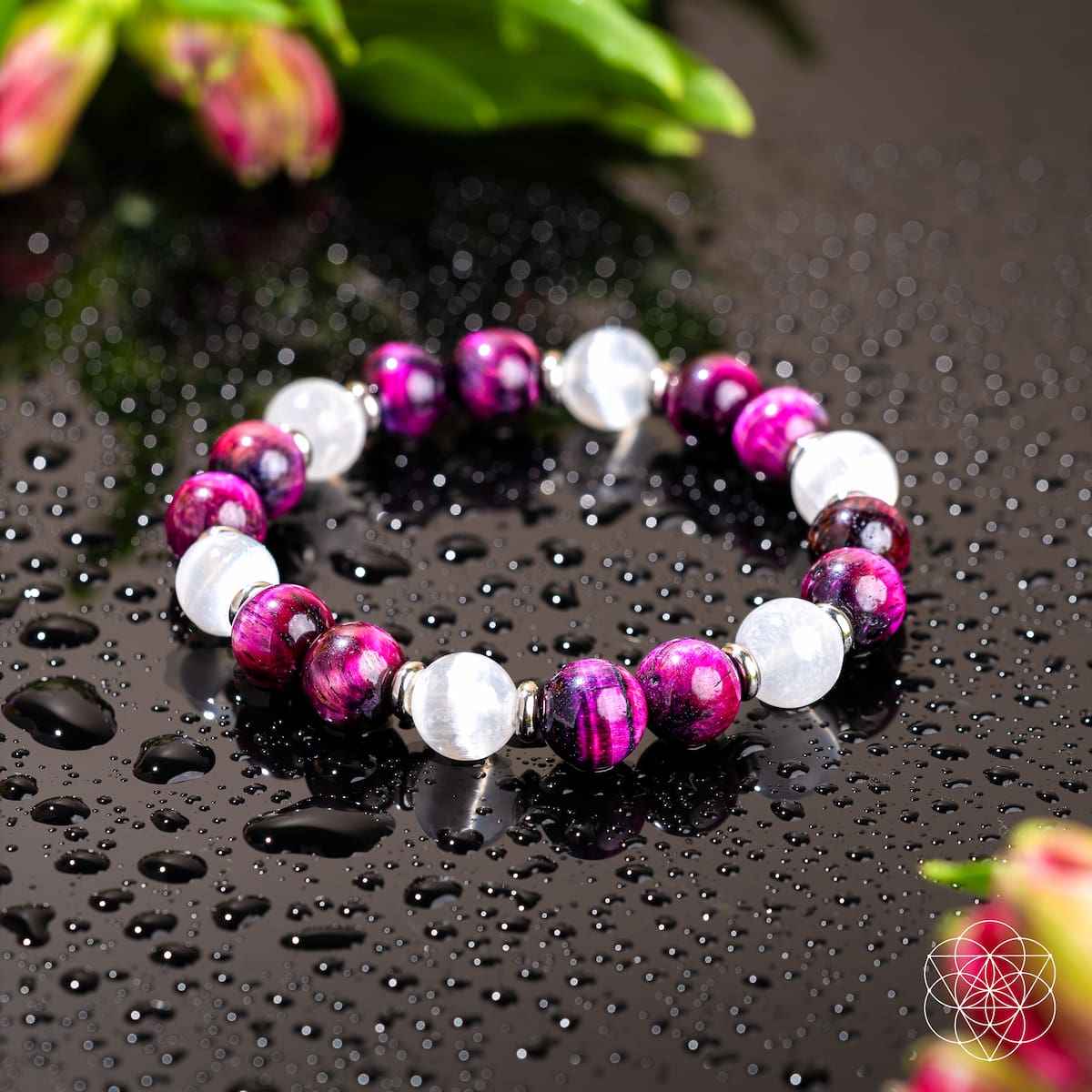 Beaded bracelet with magenta beads, white stones, and silver-toned spacers.