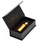 Serum bottle inside open black presentation box with gold label accents