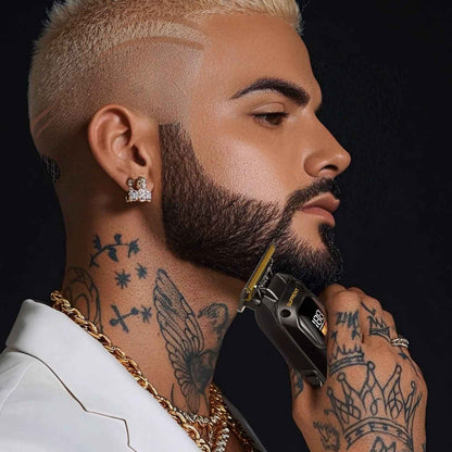 Black Scorpion beard trimmer with gold blade held to facial hair