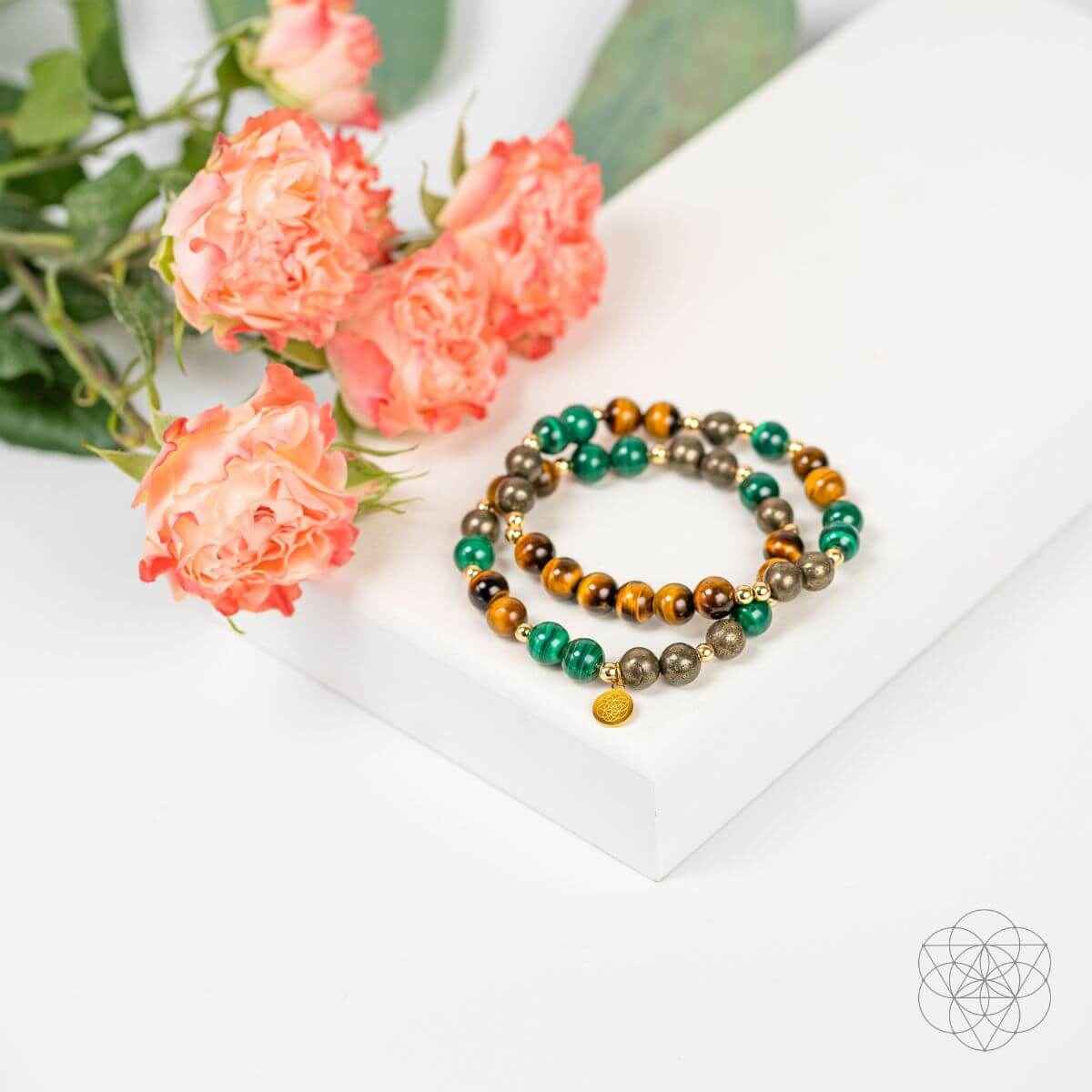 Pair of beaded bracelets featuring tiger-eye brown, green malachite-style beads, and silver tones