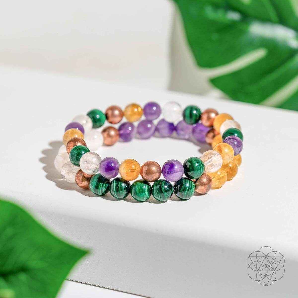 Beaded crystal bracelet with purple, green, orange, clear, and copper-toned beads