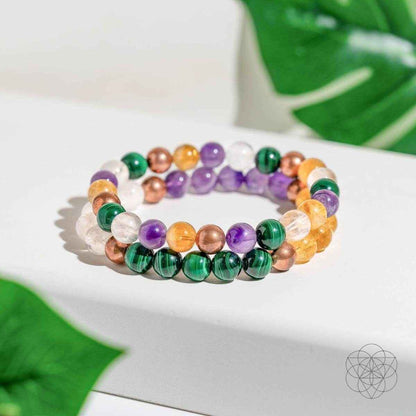 Beaded crystal bracelet with purple, green, orange, clear, and copper-toned beads