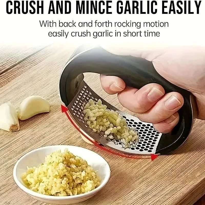 Black-handled garlic rocker press crushing garlic with minced garlic in a bowl