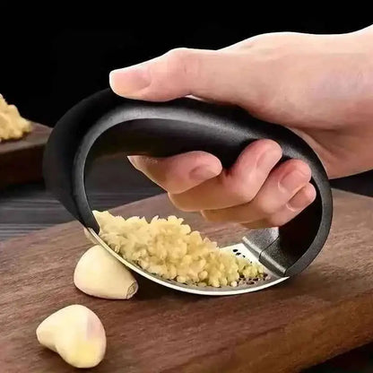 Garlic rocker press with black handle and stainless perforated grating plate
