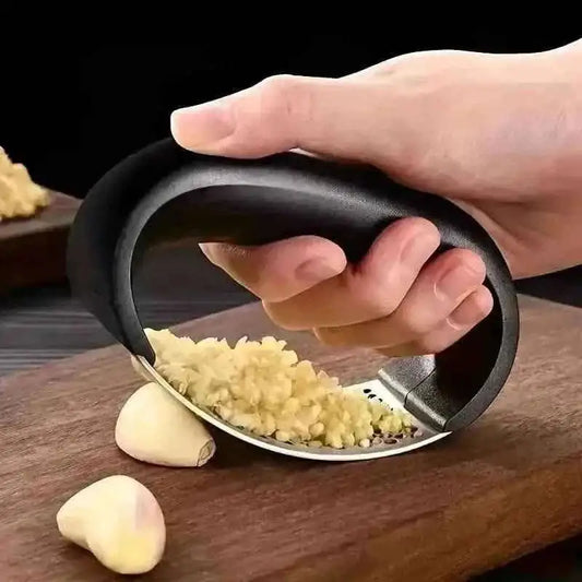 Garlic rocker press with black handle and stainless perforated grating plate