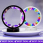 Color-changing crystal circle night light with purple multicolor ring and black base