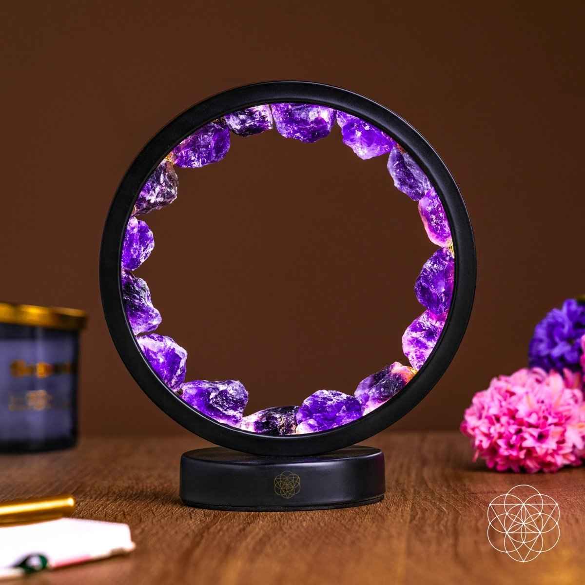 Amethyst crystal ring light with dark base and purple glowing stone segments