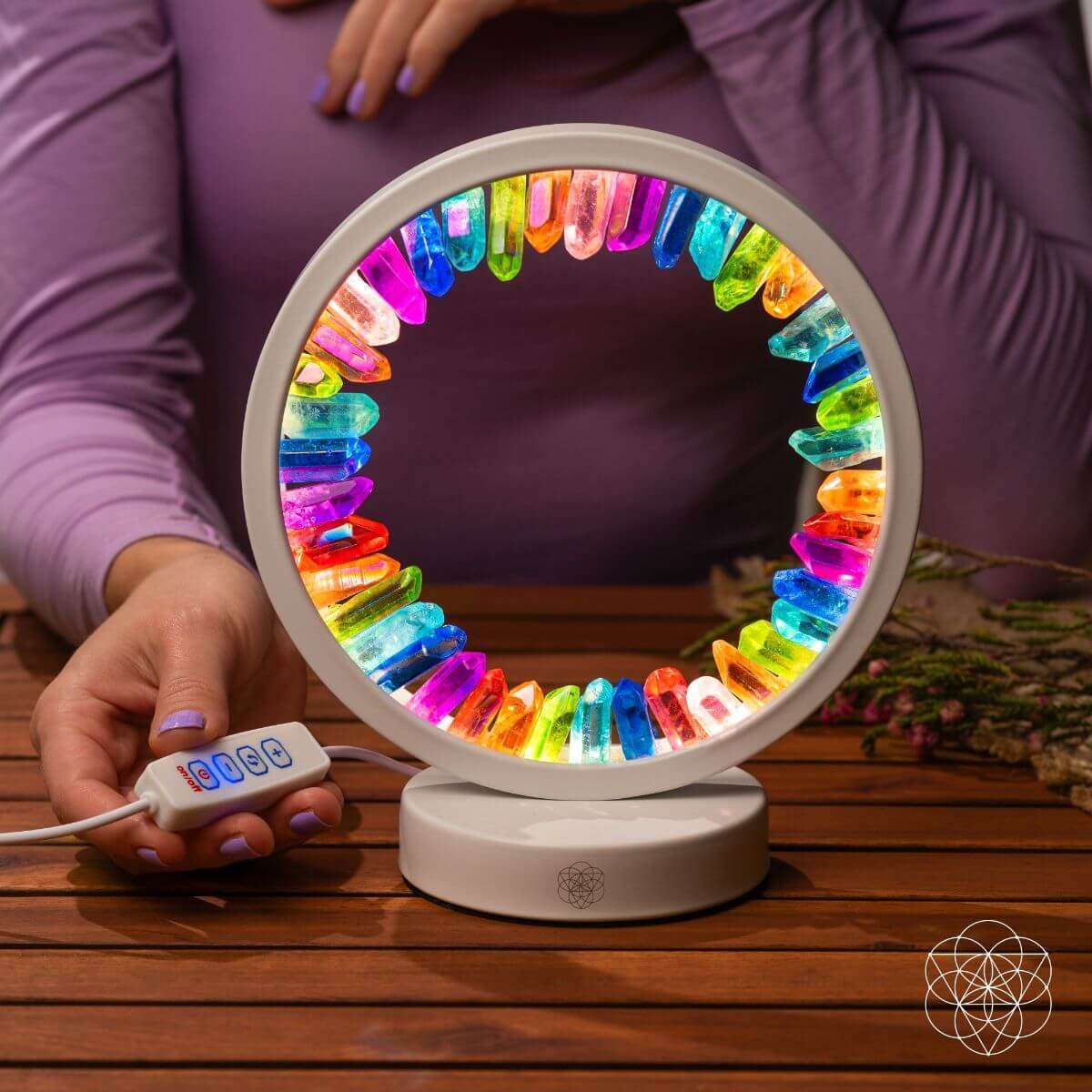 Crystal ring night light on white base with rainbow prismatic glow around the circle