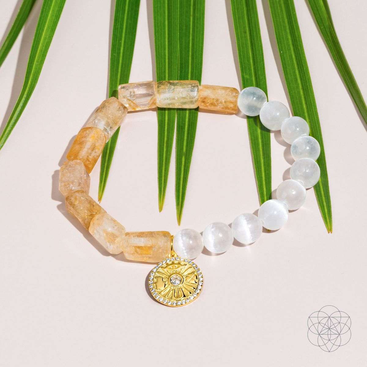 Citrine and selenite beaded bracelet with gold sun medallion charm, with green stems