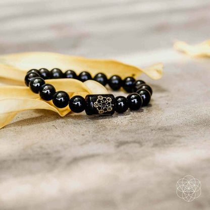 Obsidian bead protection bracelet, dark beads with gold-tone center charm