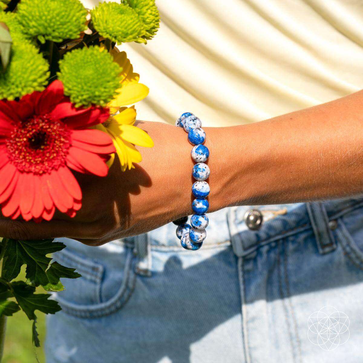 Blue and white beaded stone bracelet on wrist
