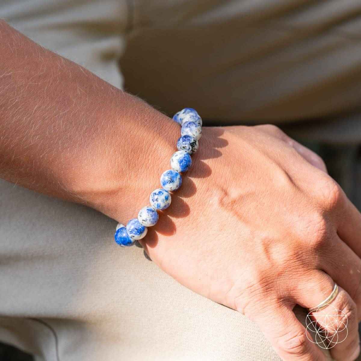 Beaded blue and white stone bracelet on hand