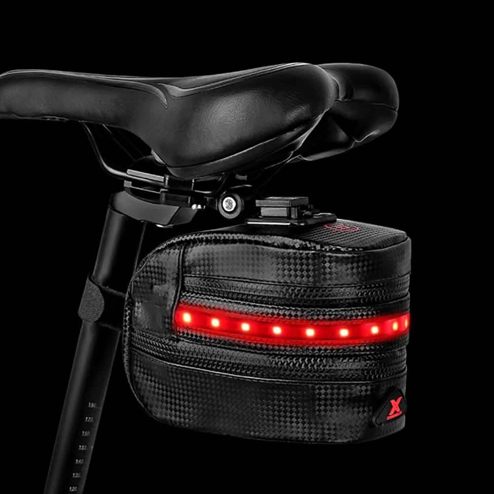 Rear bike saddle bag under black saddle; red LED strip lit along front