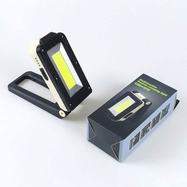 Black rechargeable folding LED light with COB panel, shown with retail box