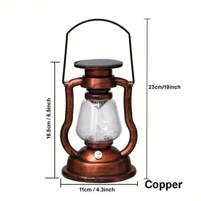 Copper retro kerosene lantern light with clear glass chamber and black top, front view.