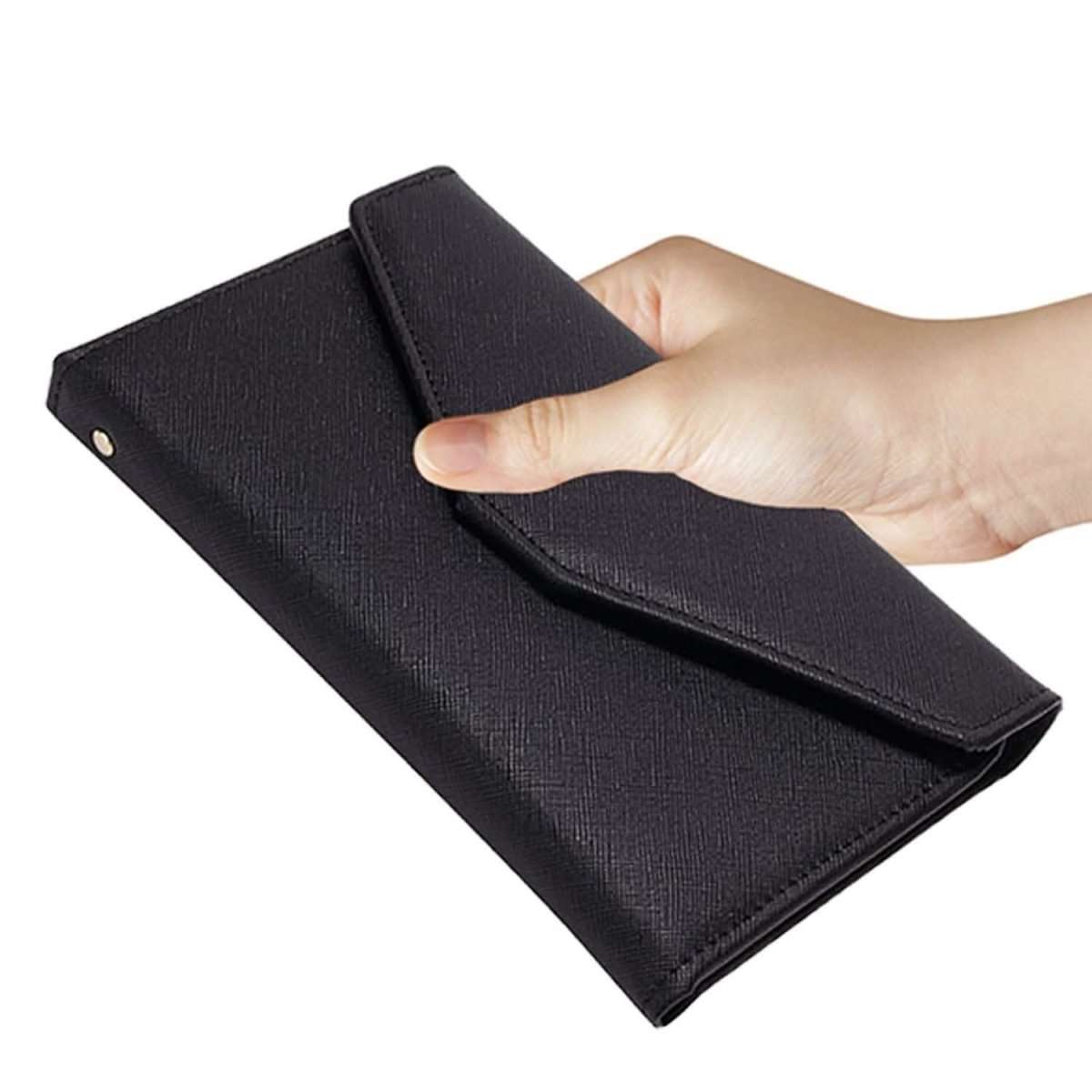 Black passport organizer wallet with snap closure and smooth flap, held in hand