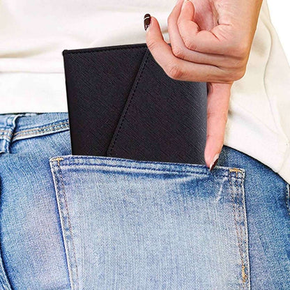 Black passport organizer wallet with textured cover and snap strap, folded for storage