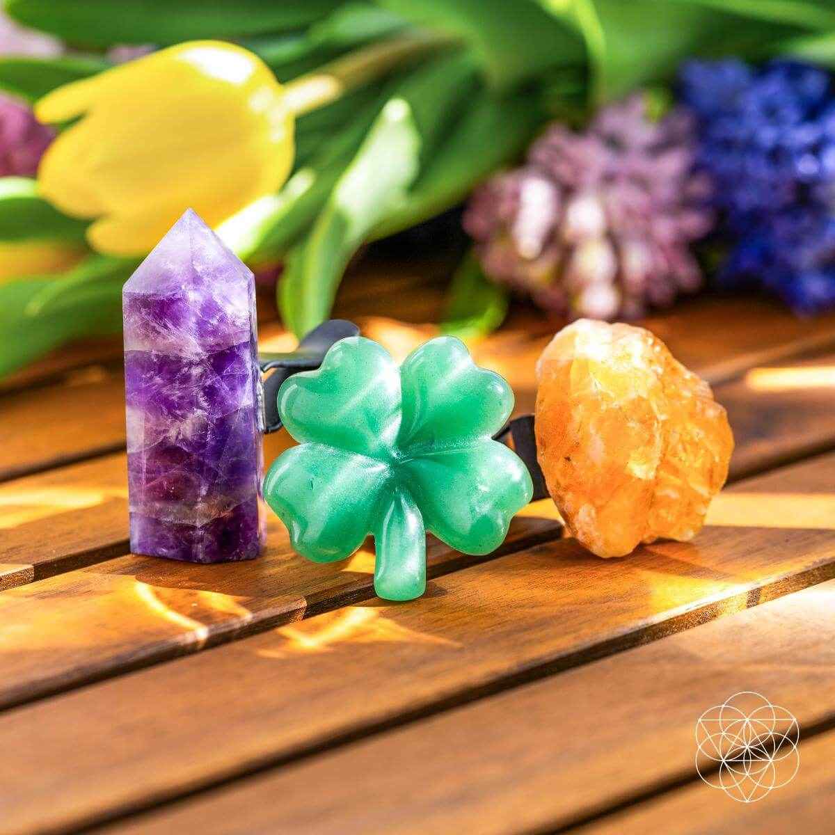 Crystal air vent clips set: purple tower, green clover, orange crystal on wooden board