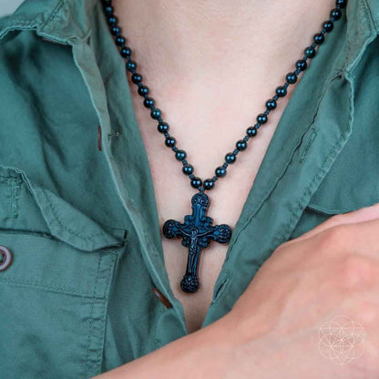 Black beaded cross pendant necklace with ornate crucifix at chest neckline