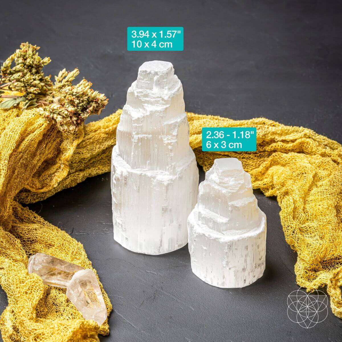 Set of white selenite cleansing lamps in three sizes on dark surface