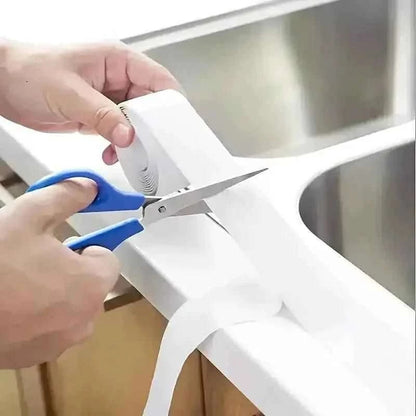 Self-adhesive waterproof caulk strip tape trimmed with scissors, white