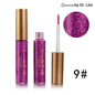 Glitter eyeliner set with fuchsia-magenta shimmer and pointed applicator tip.