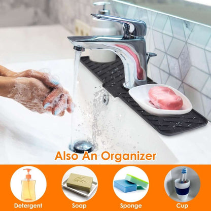 Black silicone faucet splash mat with center cutout and built-in soap or sponge area