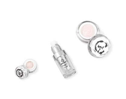 Skincare set with dropper bottle and two open cream jars
