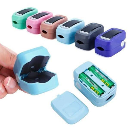 Finger pulse oximeter color options; hand holding a light blue device