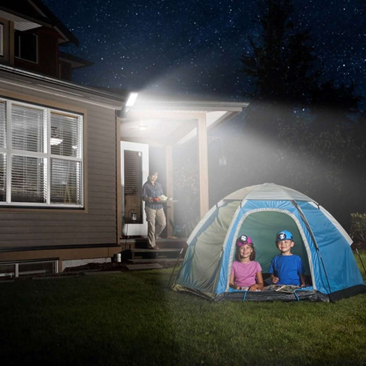 Outdoor solar wall light casting bright illumination near a house entrance at night