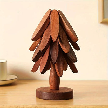 Dark wood tree coaster with carved leaf segments and circular base.