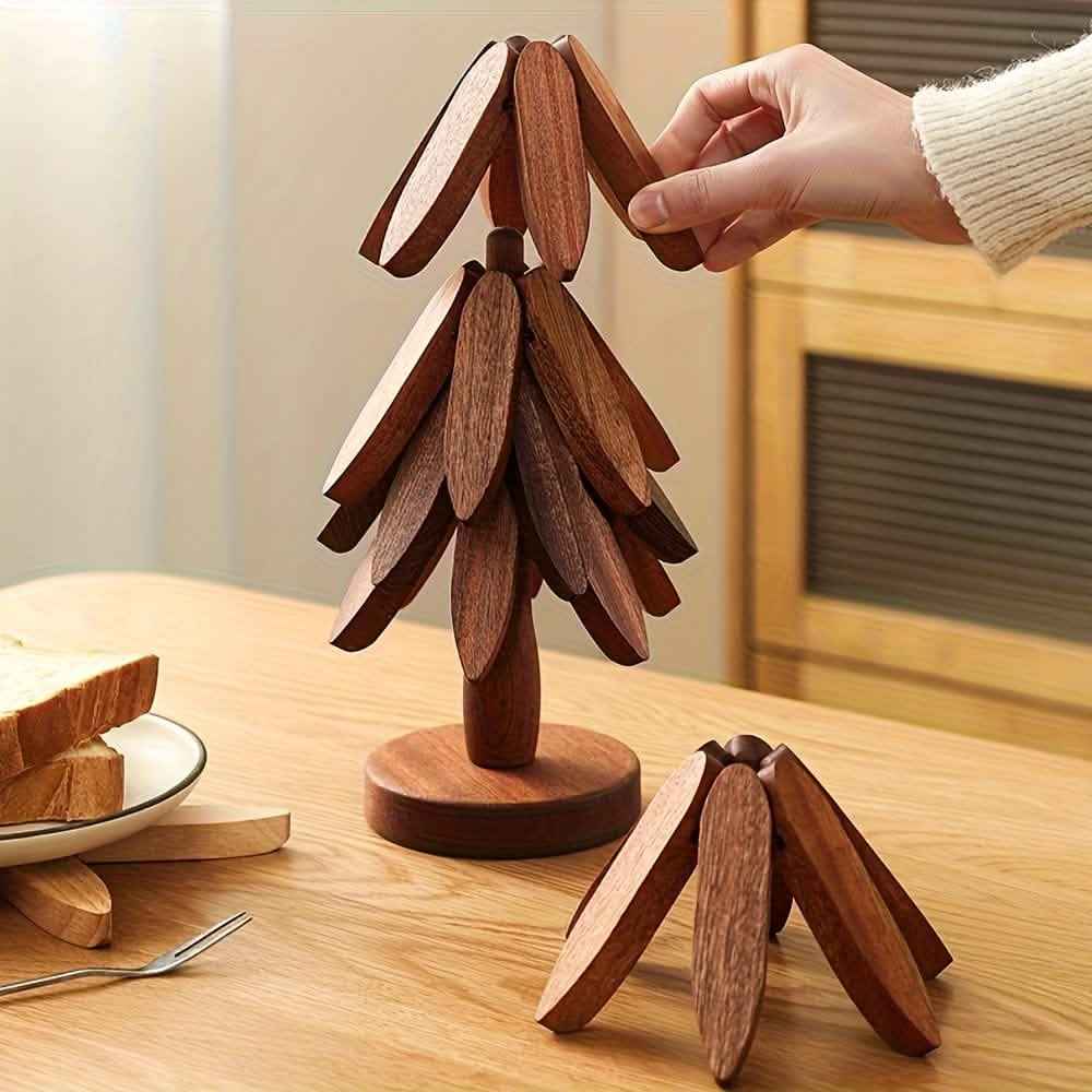 Dark wood tree-shaped coaster with stacked leaf-like pieces on a round base.
