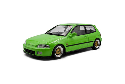 Green hatchback die-cast model car, front three-quarter view with aftermarket wheels.