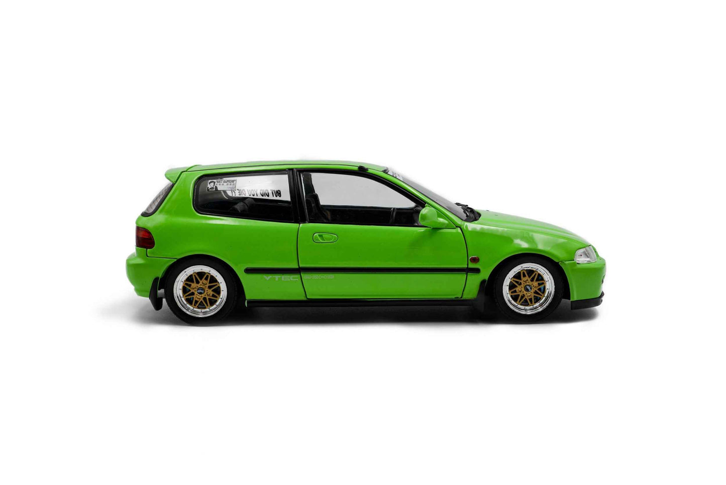 Green hatchback die-cast model car, passenger-side profile with gold wheel rims.