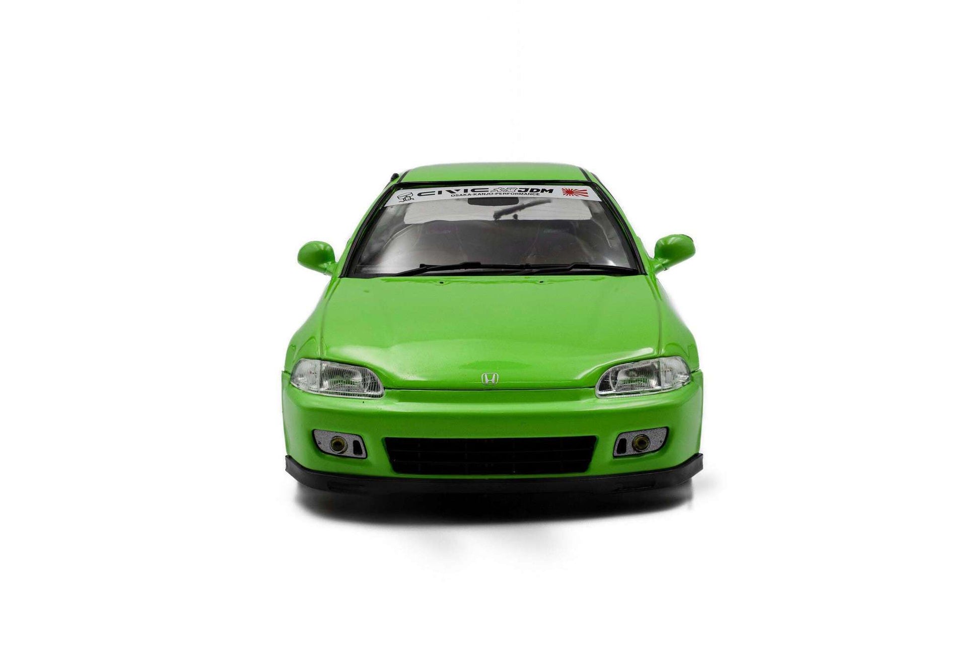 Green hatchback die-cast model car, front view with grille and clear headlights.