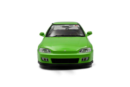 Green hatchback die-cast model car, front view with grille and clear headlights.