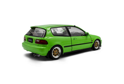 Green hatchback die-cast model car, rear three-quarter view with gold wheels.