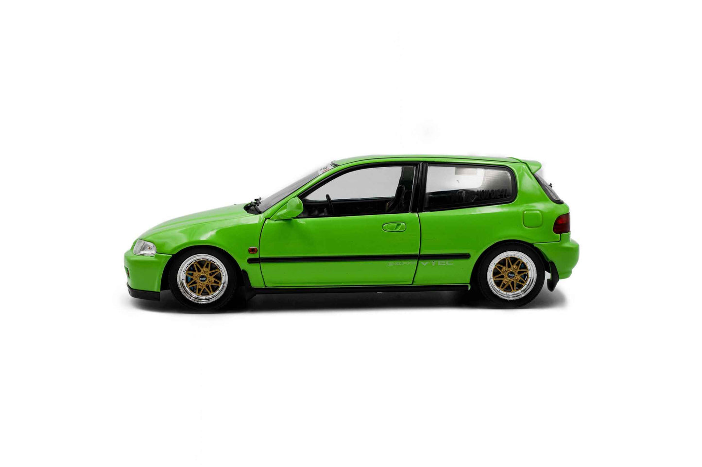 Green hatchback die-cast model car, driver-side profile with gold wheel rims.