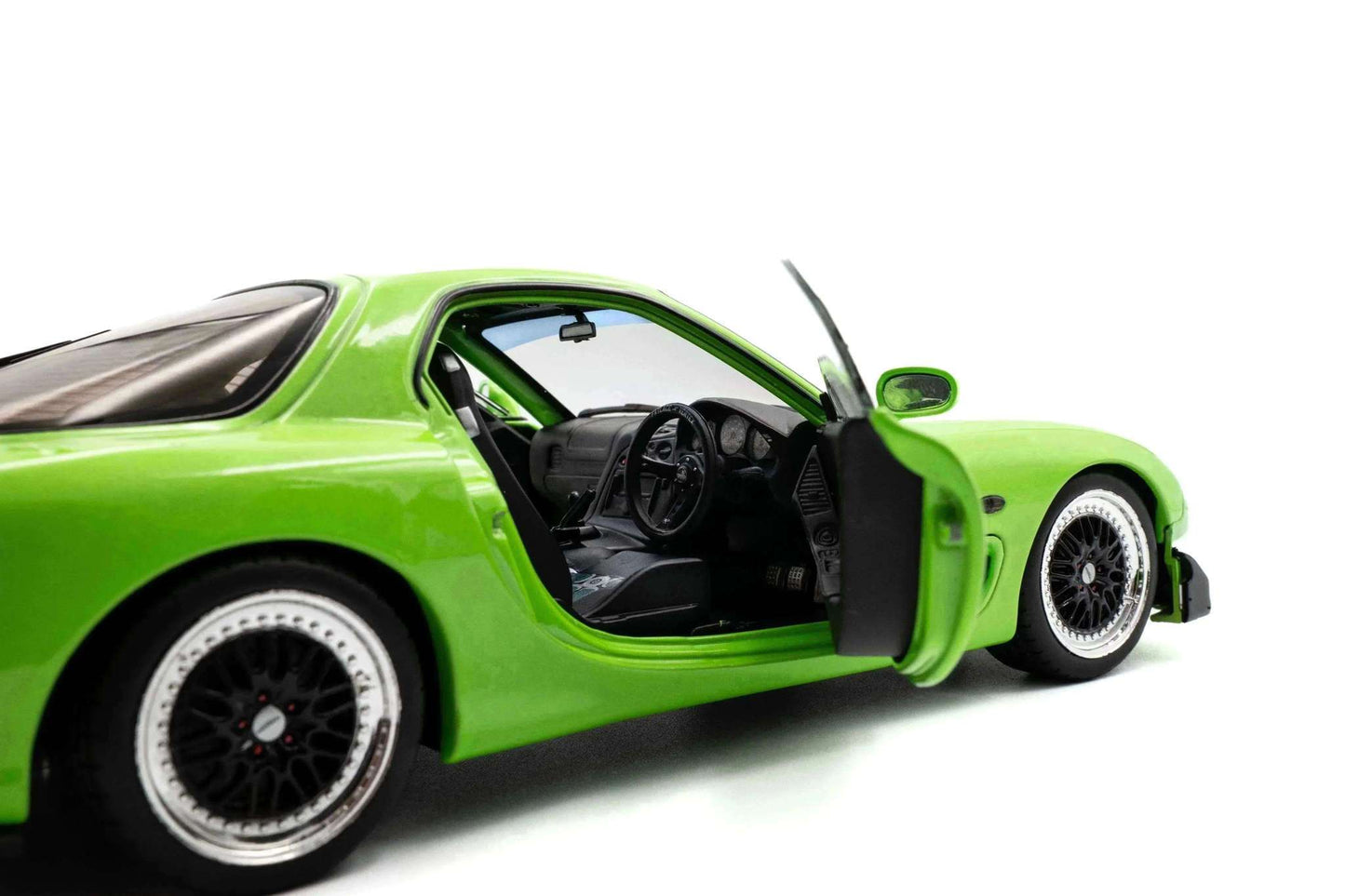 1:18 die-cast sports car in neon green, front three-quarter view with open driver door