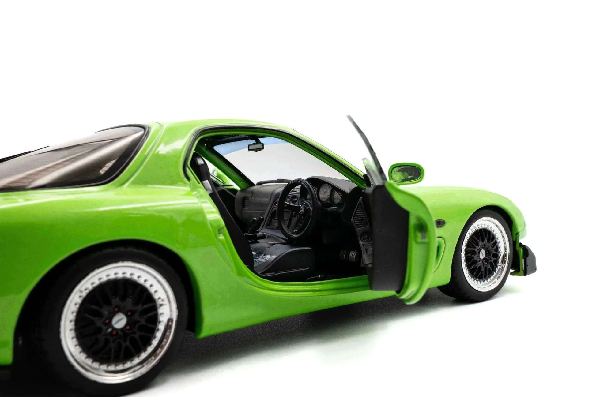 1:18 die-cast sports car in neon green, front three-quarter view with open driver door