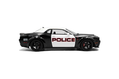 Black-and-white police die-cast car model, side view with POLICE and wheel details