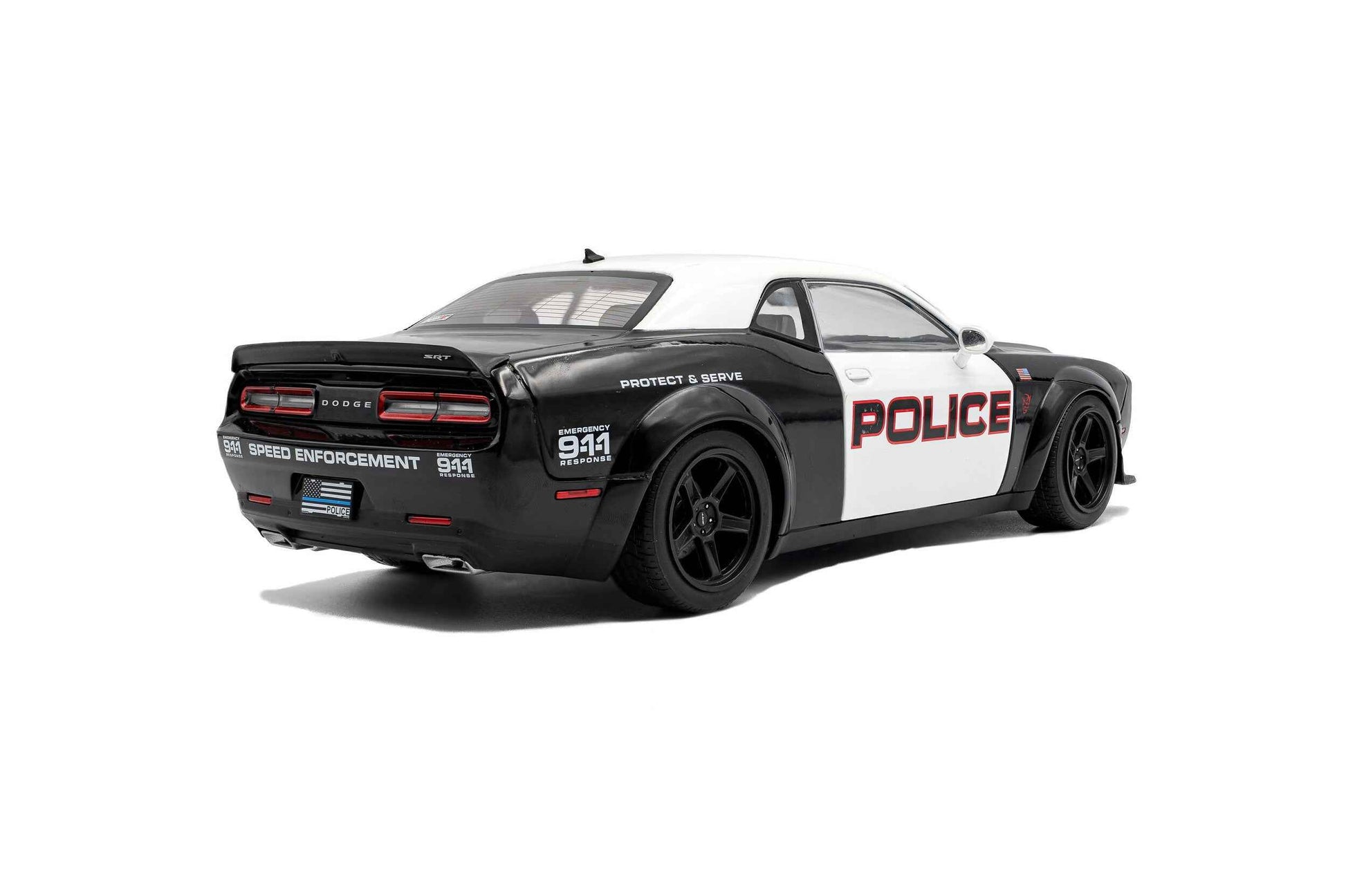 Black-and-white police die-cast car model, rear three-quarter view