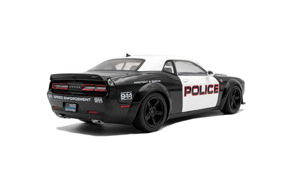 Black-and-white police die-cast car model, rear three-quarter view