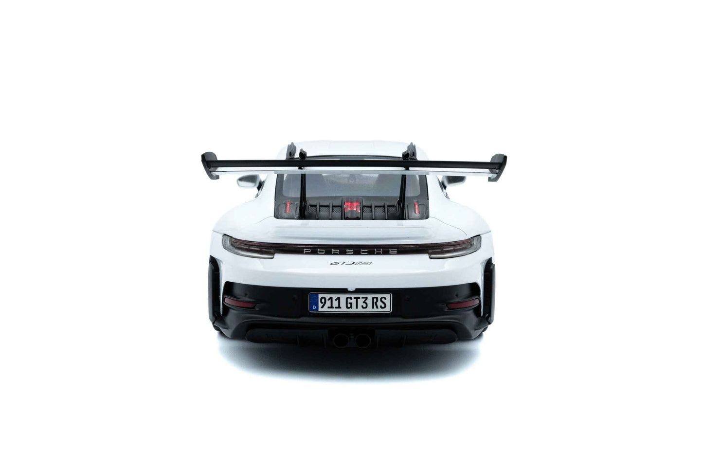 White 1:18 Porsche GT3 RS die-cast rear view with large black wing and exhaust details