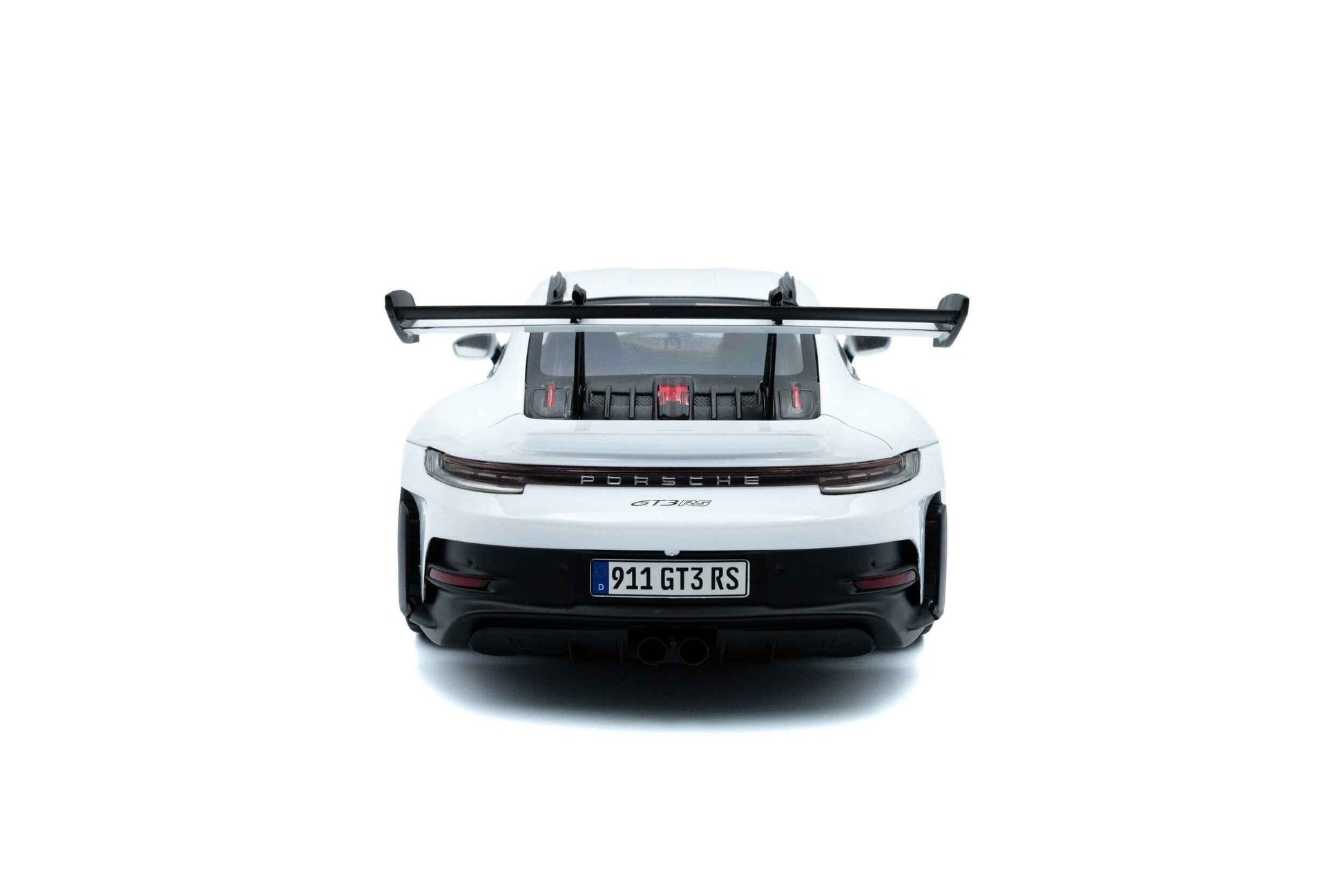 White 1:18 Porsche GT3 RS die-cast rear view with large black wing and exhaust details