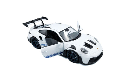 White 1:18 Porsche GT3 RS die-cast angled top view with blue livery and black wheels